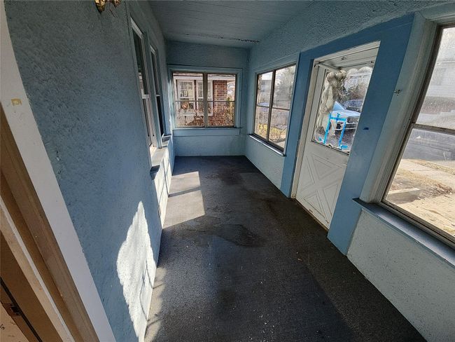 View of unfurnished sunroom | Image 11