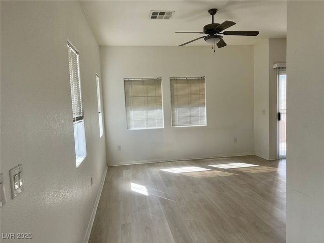 Spare room with ceiling fan and wood finished floors | Image 10