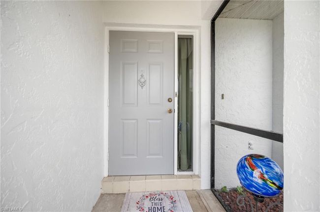 Entrance to property with stucco siding | Image 5