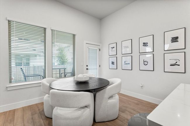 Dining space with baseboards and wood finished floors | Image 5