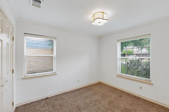 Carpeted spare room with crown molding | Image 28