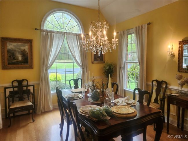 Dining area with lofted ceiling, a chandelier, and light wood-style floors | Image 7