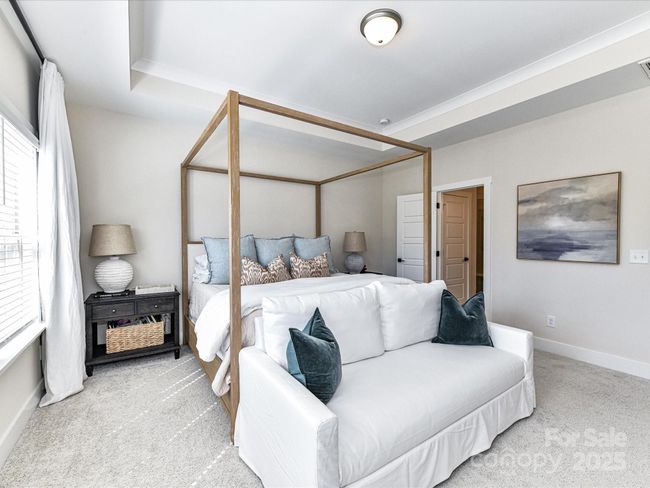 Spacious Primary Suite on upper level with tray ceiling, crown molding, tons of natural light, private bath & walk in closet! | Image 21