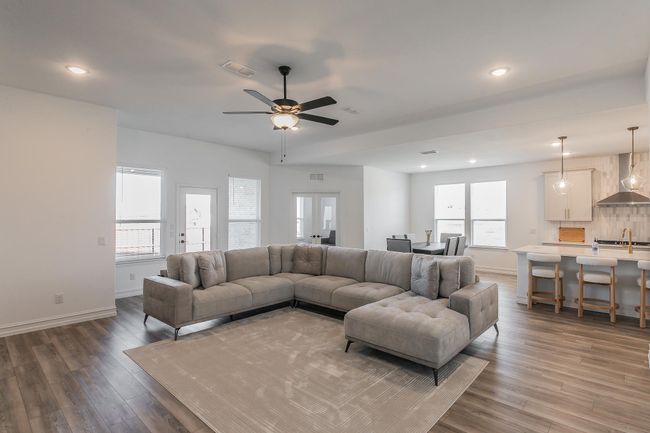Living room with ceiling fan, dark hardwood / wood-style flooring, french doors, and sink | Image 16