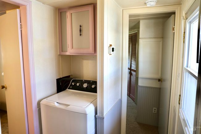 Washroom featuring washer / dryer and cabinet space | Image 17