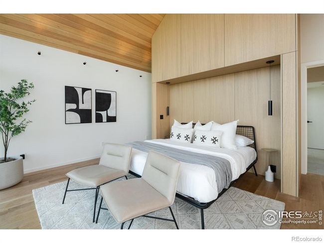 Oak bed wall rises to the ceiling, and access from both sides to the bathroom, which connects to an expansive walk-in closet with custom built-in cabinetry and full-size laundry | Image 19