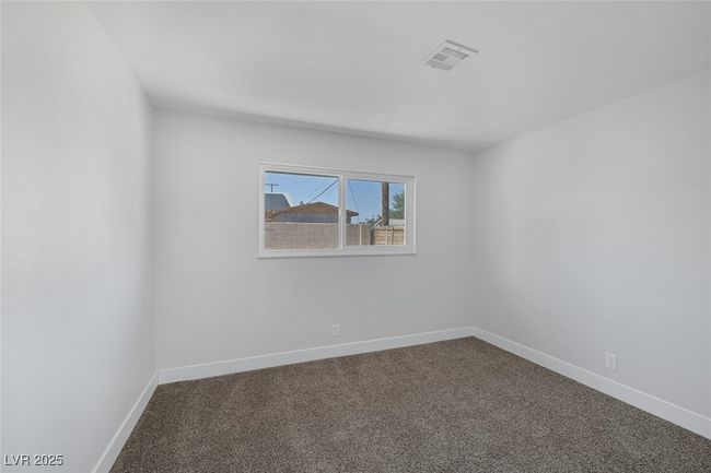 Spare room with dark colored carpet | Image 22