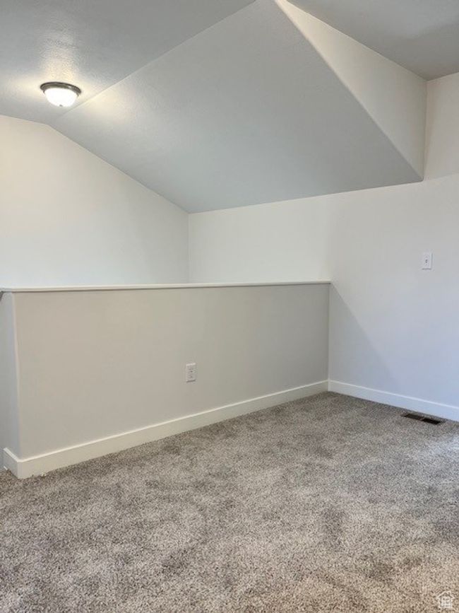 Bonus room with carpet flooring, vaulted ceiling, baseboards, and visible vents | Image 14