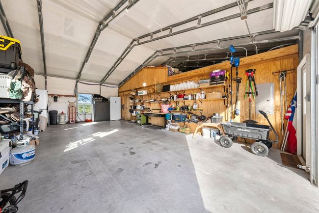Garage featuring a workshop area | Image 24