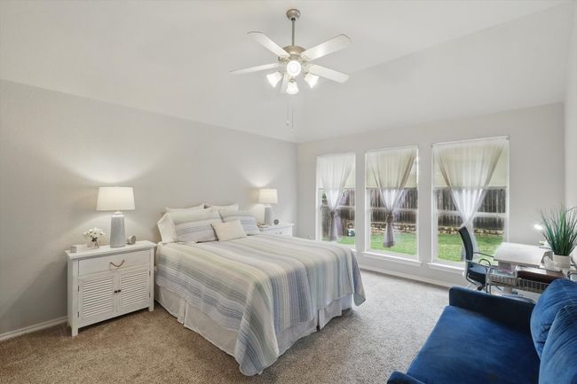 Bedroom with baseboards, ceiling fan, and light carpet | Image 22