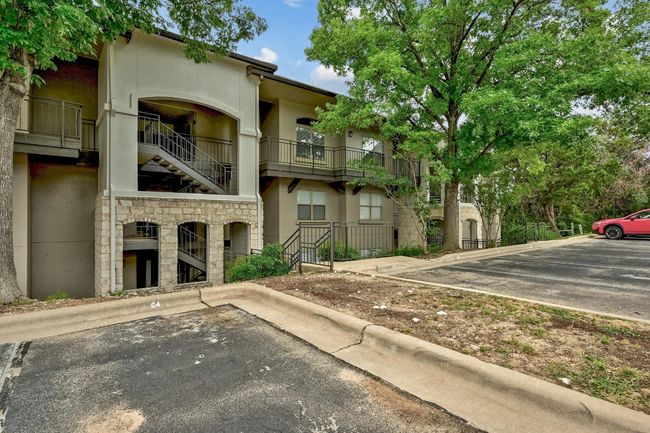 View of property featuring uncovered parking and stairway | Image 7