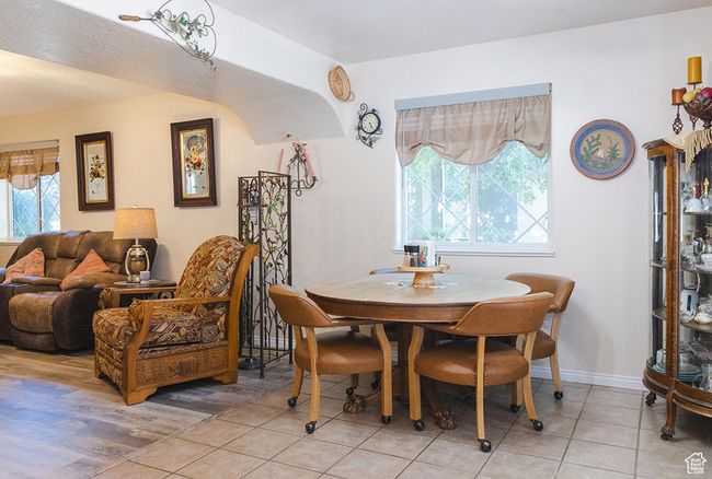 Dining room featuring light tile patterned flooring and baseboards | Image 6