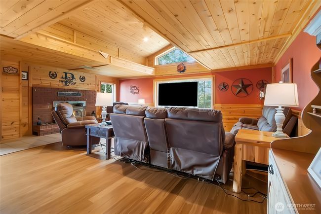 Spacious family room with cozy woodstove, vaulted ceilings & tons of natural light | Image 8