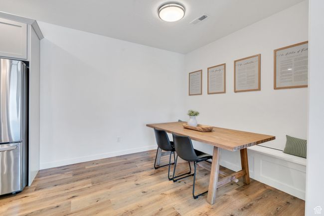 Dining area with visible vents and light wood-style flooring | Image 7