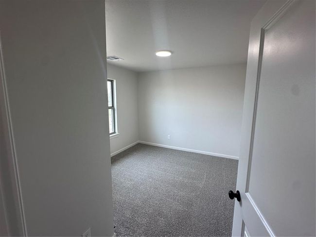 Unfurnished room with carpet floors, baseboards, and visible vents | Image 14