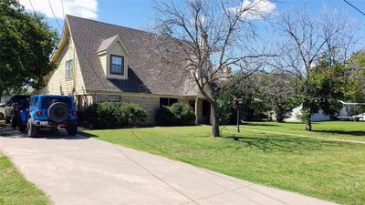 View of entrance of home with and lawn | Image 1