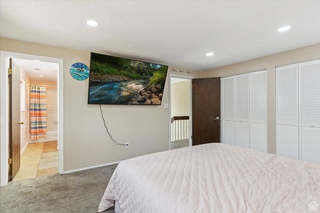 Bedroom featuring light carpet, two closets, recessed lighting, and ensuite bathroom | Image 17