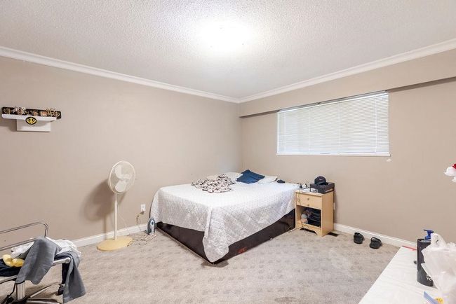Carpeted bedroom featuring ornamental molding and a textured ceiling | Image 22