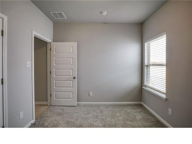 Carpeted empty room with a smoke detector and baseboards | Image 18