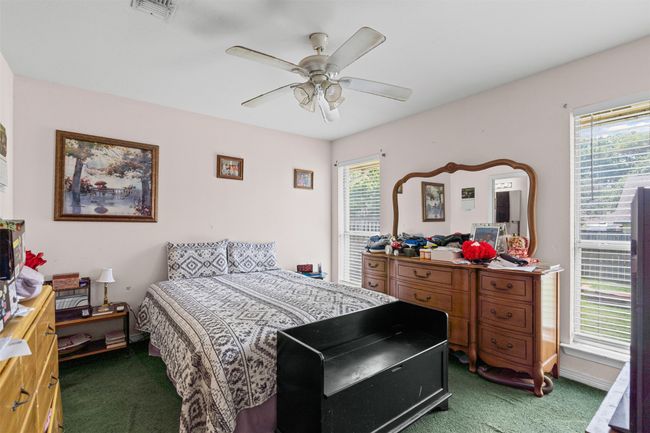 Carpeted bedroom featuring a ceiling fan | Image 14
