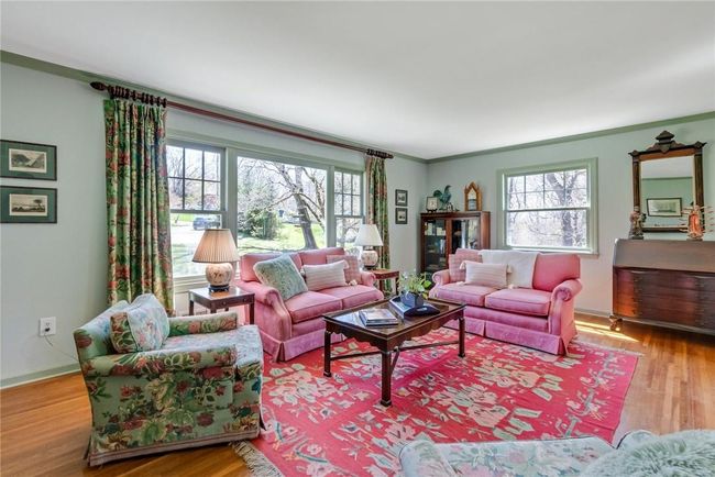 Spacious living room with wood floors opens to the dining room with door to the rear deck and views of the Hudson River. | Image 4