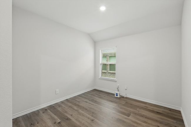 Unfurnished room featuring wood finished floors, vaulted ceiling, and recessed lighting | Image 9
