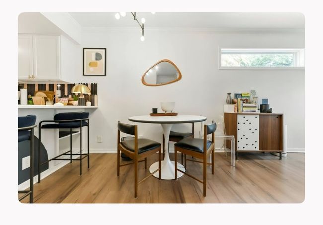 Dining area with light wood-type flooring, crown molding, and baseboards | Image 11