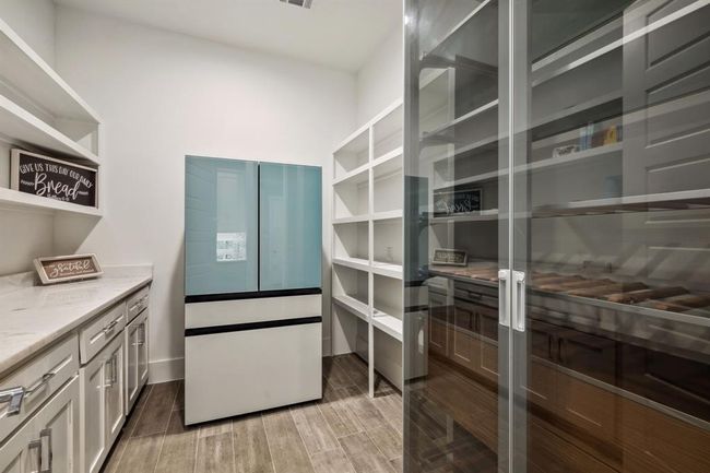 The kitchen boasts a spacious butler’s pantry and abundant storage, offering both functionality and elegance. | Image 18