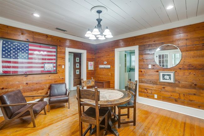 Dining space featuring a chandelier, wood walls, light wood-type flooring, recessed lighting, and ornamental molding | Image 20