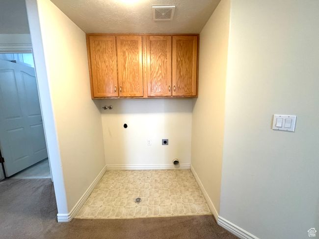 Washroom featuring electric dryer hookup, built-in cabinets. | Image 30