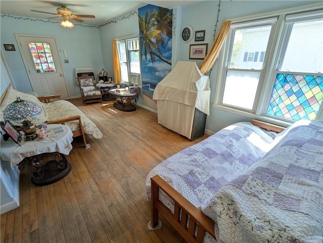 Bedroom with hardwood / wood-style flooring, baseboards, and a ceiling fan | Image 24
