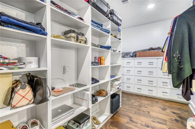 Spacious closet featuring dark wood-type flooring | Image 26