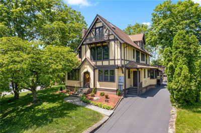 Tudor-style house featuring a front lawn | Image 1