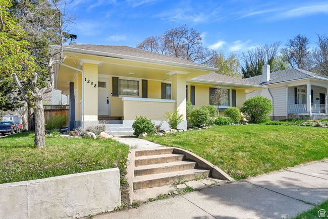 View of front facade featuring a front lawn, brick siding, and a porch | Image 32