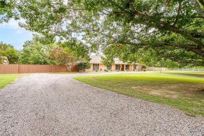 Notice the wide circle drive and gate to the backyard and garage | Image 2