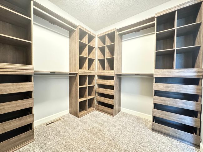 Owner's Walk-in Closet features Built-In Shelves and Drawers | Image 10