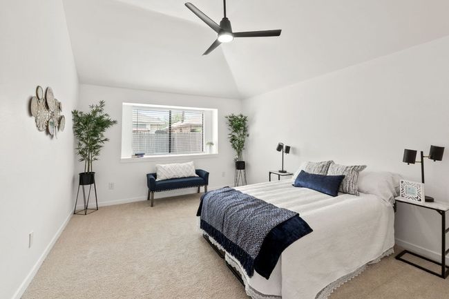 Main Bedroom with lofted ceiling, carpet flooring, baseboards, and ceiling fan | Image 22