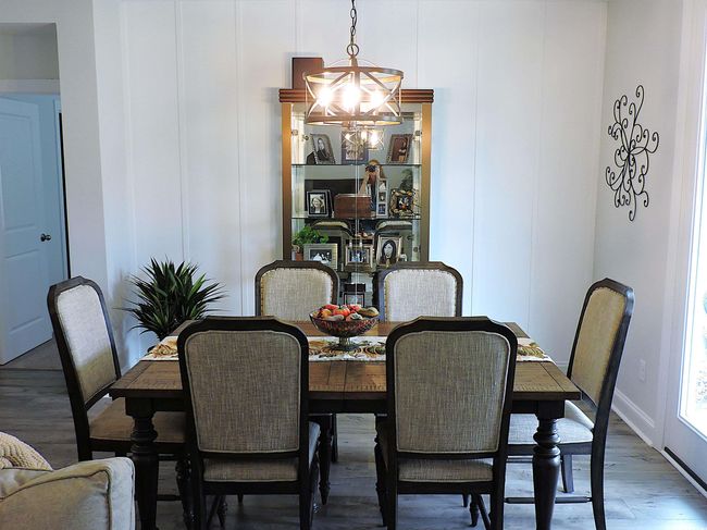 Dining room featuring a chandelier and wood finished floors | Image 13