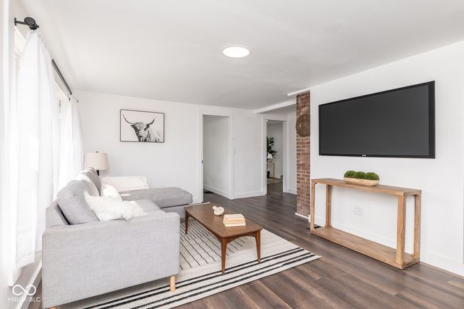 living area featuring baseboards and dark wood-type flooring | Image 5