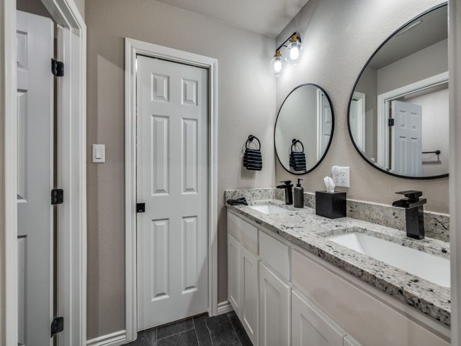 Full bathroom featuring double vanity and baseboards | Image 19
