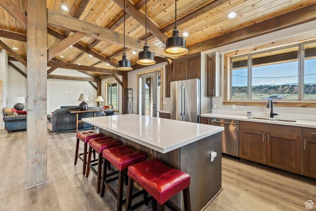 Kitchen featuring a sink, open floor plan, stainless steel appliances, and wooden ceiling | Image 32