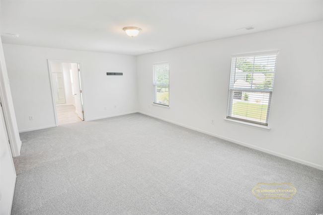 Unfurnished room with plenty of natural light, light colored carpet, and baseboards | Image 20