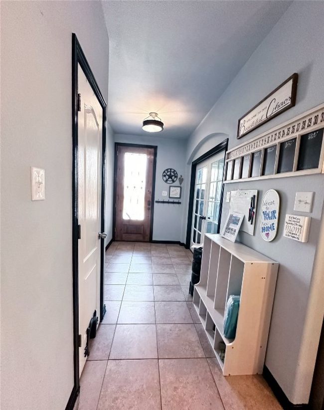 Doorway to outside with plenty of natural light, light tile patterned floors, and french doors | Image 7