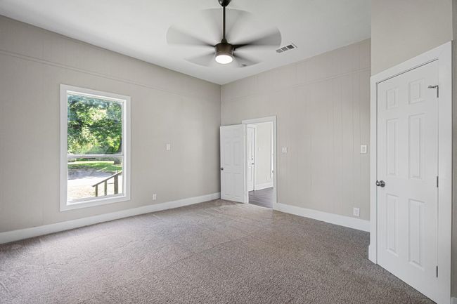 Unfurnished bedroom featuring carpet floors and ceiling fan | Image 14
