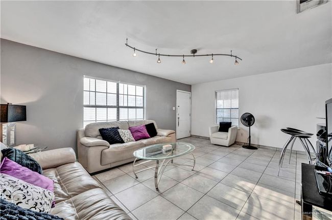Living area with light tile patterned floors | Image 6