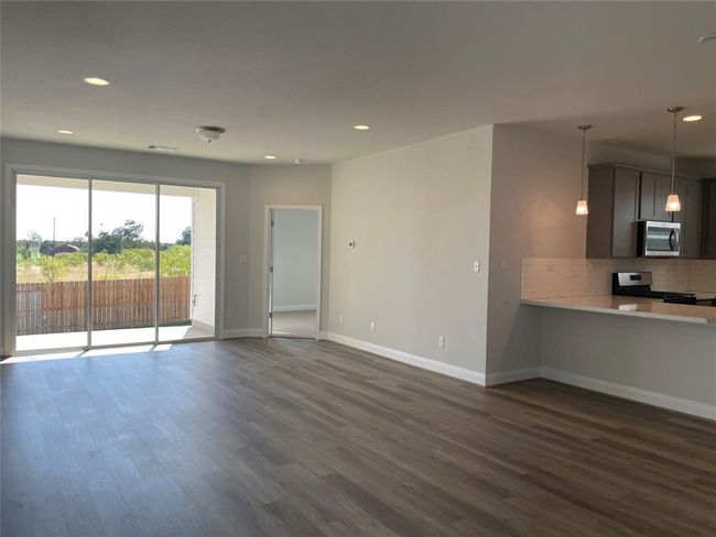 Unfurnished living room featuring dark wood finished floors and recessed lighting | Image 4