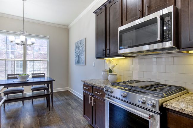 Kitchen with gas cooktop and under-cabinet lighting. | Image 12