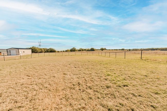 View of yard with fence, a detached garage, and a rural view | Image 39