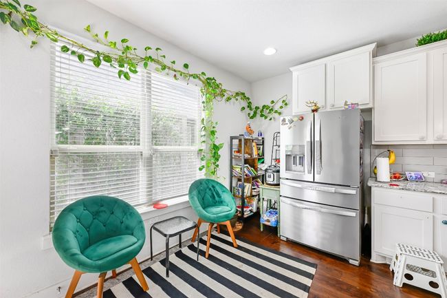 Kitchen with stainless steel fridge, backsplash, white cabinets, dark wood-style flooring, and recessed​​‌​​​​‌​​‌‌​‌‌​​​‌‌​​‌‌​‌​​​​​‌ lighting | Image 10