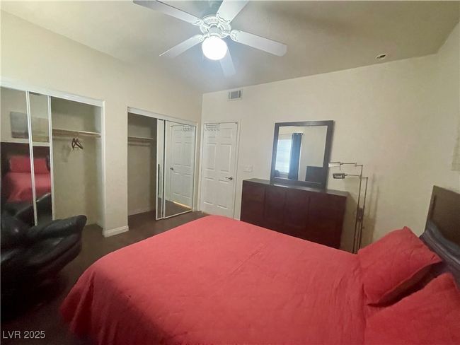 Bedroom with visible vents, two closets, and a ceiling fan | Image 40